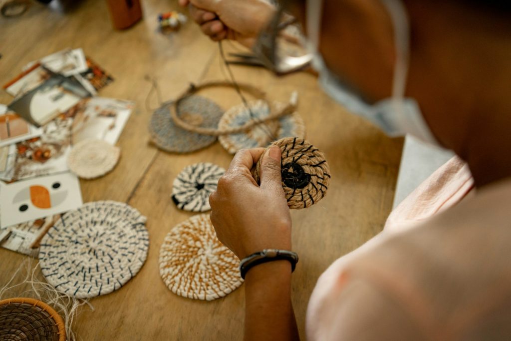 A woman is working on a piece of art