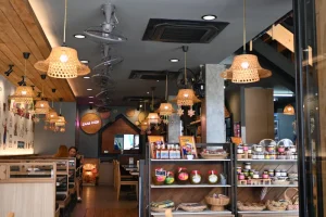 Handwoven wicker pendant lamps glowing in a cafe