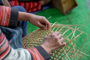 Hands weaving rattan in a workshop