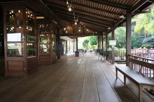 Covered outdoor walkway with seating and hanging lights